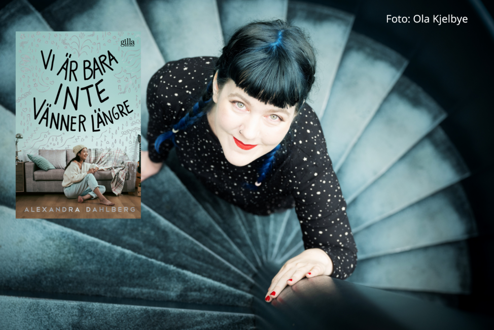 Flicka i svarta kläder står i en trappa, till vänster ett bokomslag